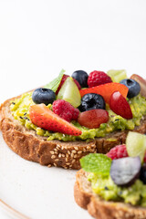 Avocado toast with strawberry, blueberry, raspberry and grape. Healthy eating