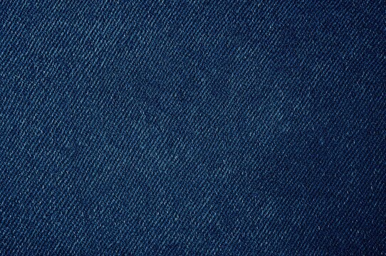 Close-up of dark blue denim fabric texture and weaving pattern