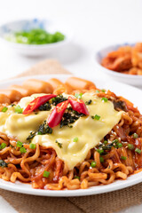 Korean spicy instant noodles with kimchi, sausage and mozzarella cheese