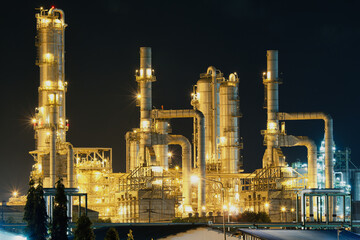 Oil refinery plant with dark sky background at night. Large heavy industry in Map Ta Phut...