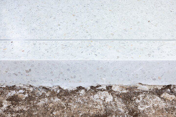 Terrazzo floor at side view. Floor finishing material. Construction for decorative surface by cover...
