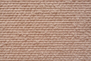 Fototapeta premium Detailed shot of a woven fabric featuring horizontal patterns in earthy hues, ideal for cozy home or apparel designs