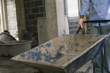 A skilled bricklayer works with mortar and trowel, carefully building a brick wall at a construction site with strength and precision.