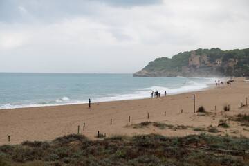 Altafulla beach with Tamarit Castle on forested hill – Costa Daurada