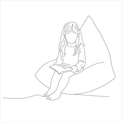 girl is reading a book on the sofa