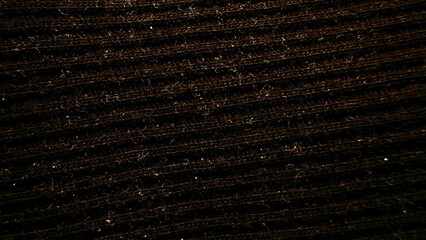 close-up textured brown fabric with fine ribbed pattern illuminated by soft light ideal for wallpaper or commercial background use