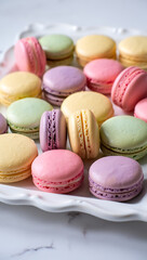 Obraz premium A collection of colorful french macarons in various pastel shades, arranged on a decorative white platter