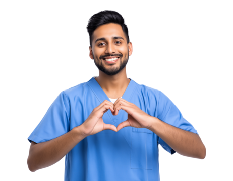 A cheerful young male doctor or nurse in blue scrubs smiles warmly while making a heart shape with his hands, symbolizing care and compassion isolated on a transparent background
