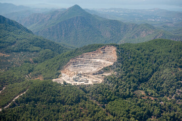 Stone quarry in forested mountain landscape of Mediterranean Turkey