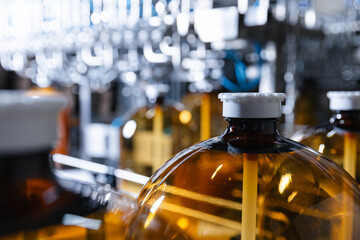 Modern beer production facility with bottling equipment and amber glass bottles