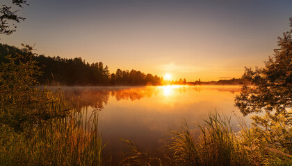 Fototapeta premium Tranquil Lakeshore Scene At Golden Sunrise With Glow Of Soft Light