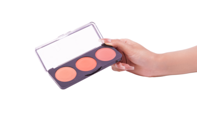 Womans hand holding a makeup palette with peachy coral blush shades.