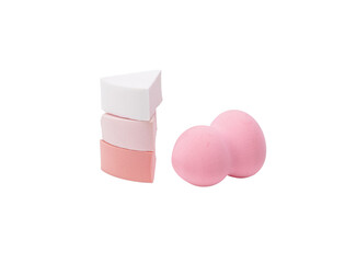 Collection of various pink and white makeup sponges for cosmetic application.