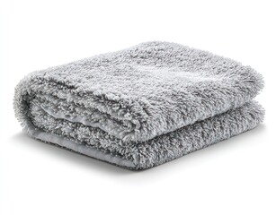 Soft, folded gray microfiber towel, slightly blurred, casting a subtle shadow on a white surface
