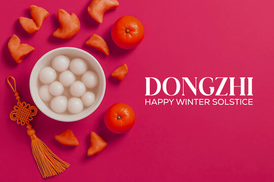 Dongzhi festival food with glutinous rice balls and tangerines on pink background