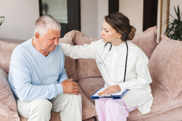 Fototapeta premium Nurse came to visit an elderly patient at home. Doctor tells an senior man about a bad diagnosis