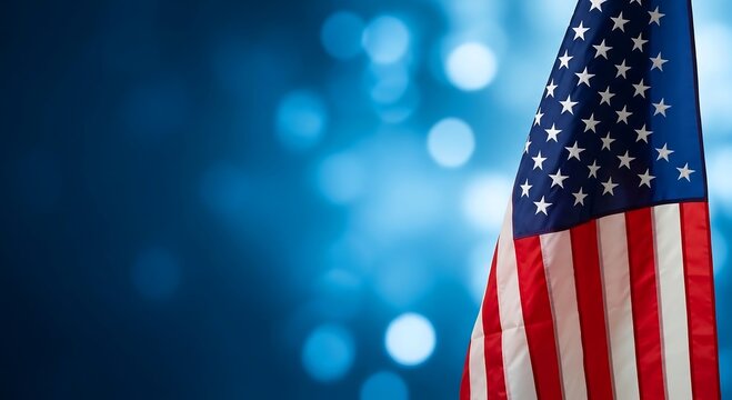 American flag waving against a blue bokeh background for independence day