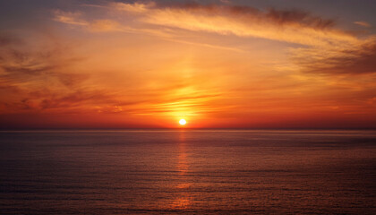 Sunset Paints The Sky With Orange And Red Hues As The Sun Dips Below The Horizon Casting A Golden Glow On The Calm Ocean