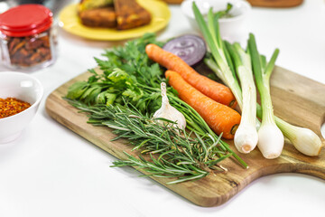 Fresh vegetables and herbs on wooden board