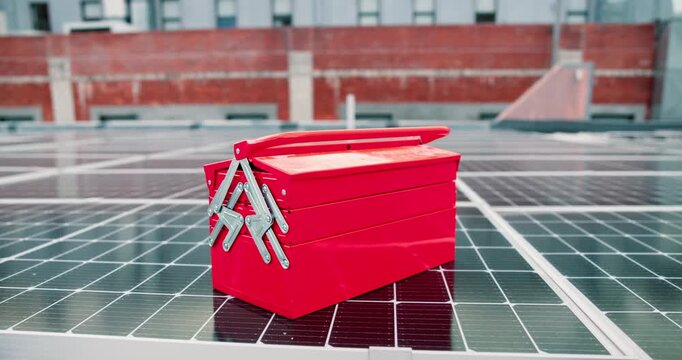 Toolbox, solar panel and sustainability outdoor on rooftop with electrician equipment for environment. Urban development, innovation and clean energy for grid, engineering or photovoltaic maintenance