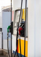 Portrait shot of Gasoline diesel Fuel dispenser. Filling Fuel pumps station, oil pump and nozzles at gas station on the street at daytime
