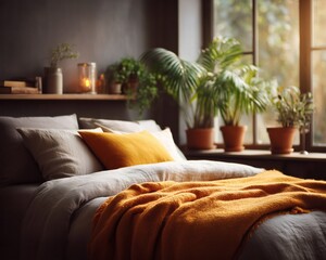 Modern bedroom with white bedding, orange blanket and cushion on bed near window with green plants and candles.