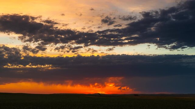 Colorful sunset clouds slowly drift in fading evening light 