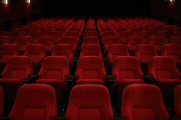 Fototapeta premium Vacant red chairs in a cinema hall for television streaming and film production branding