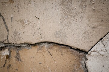 Close-up view of a weathered and cracked wall section from a deserted building. Artistic backdrop