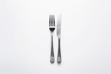 Cutlery set comprising a fork and knife against a white backdrop