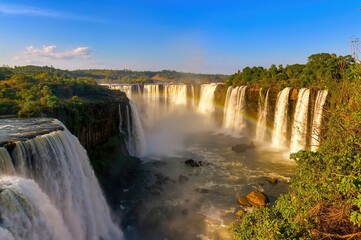 Scenic panorama of a famous waterfall in Africa from the lush riverside