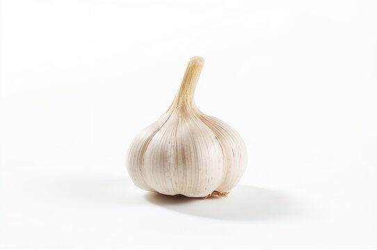 Intense close-up of garlic bulb against plain white backdrop