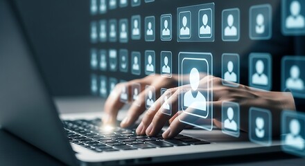 Close up of hands typing on a laptop keyboard with a futuristic digital interface displaying a grid of user profile icons and avatars representing a network of people
