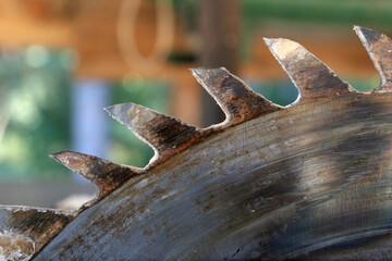 Rusty circular  saw blade teeth close up view.