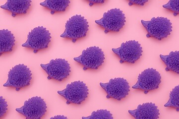 Lavender plastic hedgehog figurines set against a soft pink backdrop. Artistic and abstract theme.