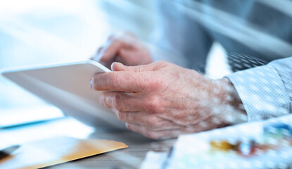 Businessman working on digital tablet; light effect