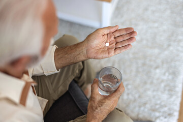 Home medicine, hands or senior person with pills tablet, medication and pharmaceutical prescription...