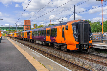 Fototapeta premium Electrified suburban passenger rural commuter railway line England UK