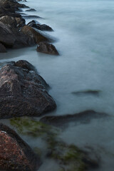 Waves of the baltic sea at the beach, long exposure, stones