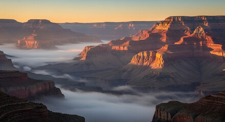 Breathtaking morning view of the Grand Canyon with golden sunlight illuminating the peaks above a sea of fog