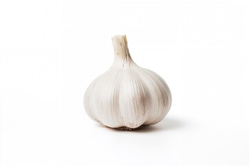Single garlic bulb on a plain white surface