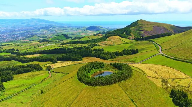 Lake Pau Pique and Lush Green Hills. Atlantic Ocean. Azores, Sao Miguel Island. Portugal. Aerial View. Orbiting