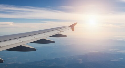 Obraz premium 青空と白い翼 飛行機窓からの景色