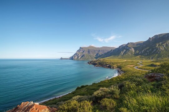 Seaside view of an island with mountains under a summer sky, featuring a coastal road and natural landscape