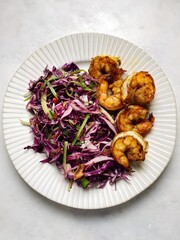 Delicious Red Cabbage Salad with Spicy Shrimp on a White Plate
