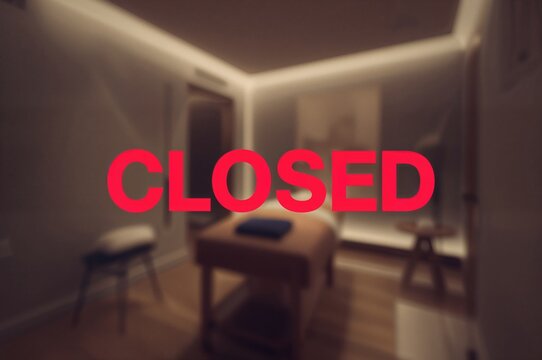 Covid-19 Closure Notice. Blurred Massage Room Background.