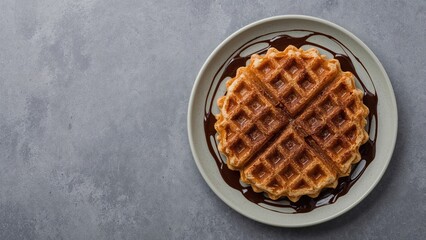 Close-up of a Croffle served on a plate with chocolate drizzle against a neutral background
