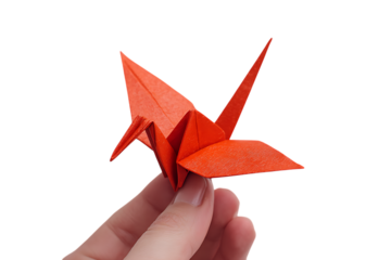 Hand holding a red origami crane.