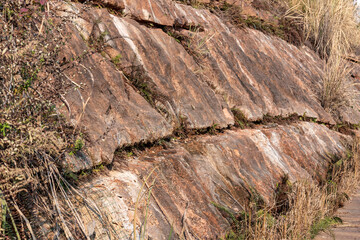 Red stone wall full of traces