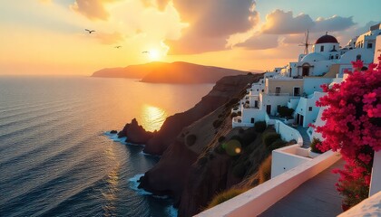 Santorini village at sunset with whitewashed buildings and pink bougainvillea flowers on the cliffside